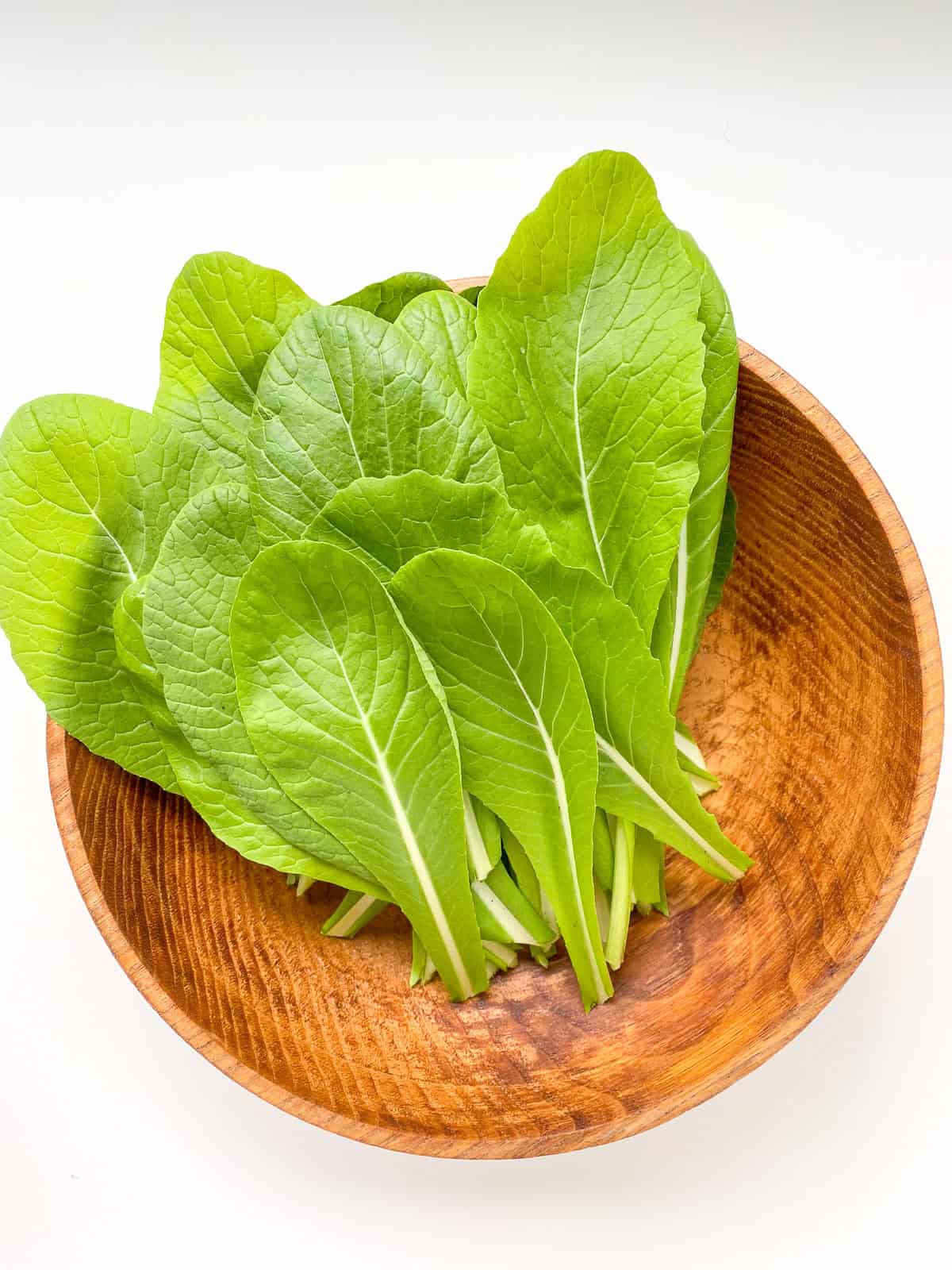 An image of komatsuna greens on a white background.