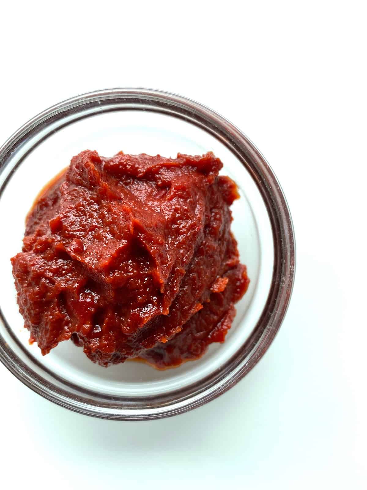 An image of a small glass bowl filled with Turkish Tomato and Pepper Paste.