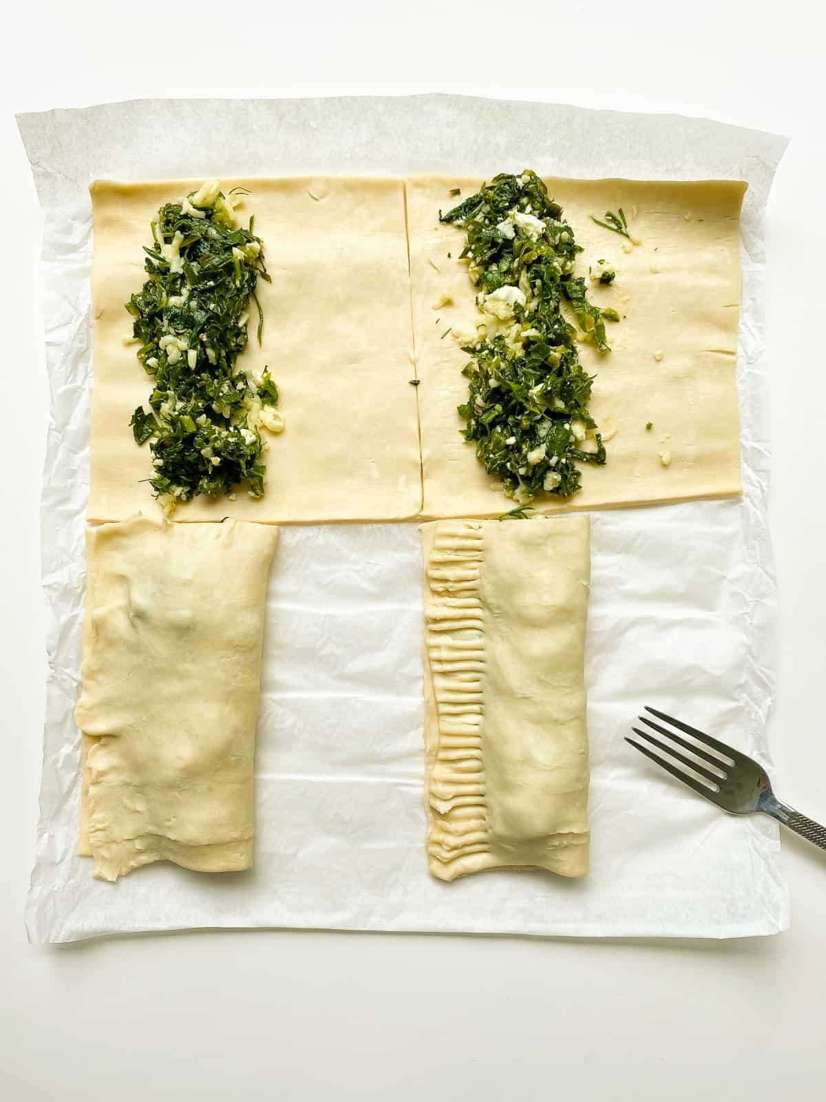 An image of puff pastry rolls being folded and crimped before baking.