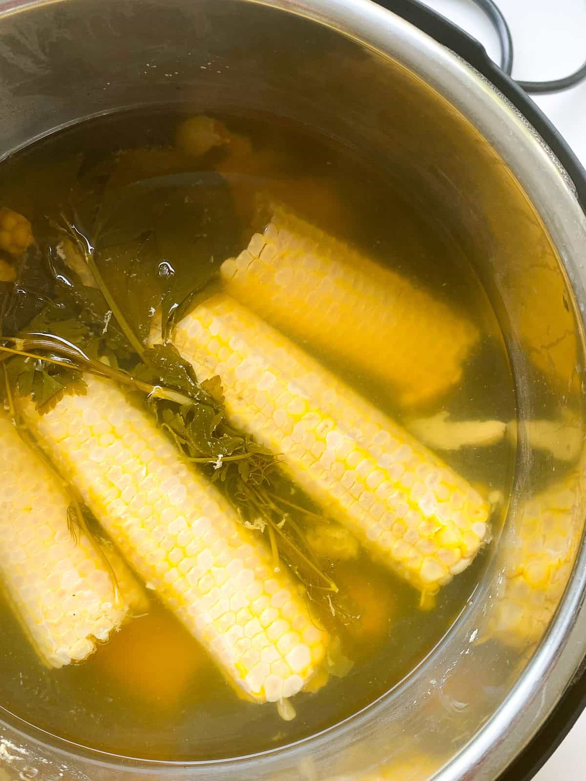 An image of unstrained corn broth in the inner bowl of an Instant Pot.