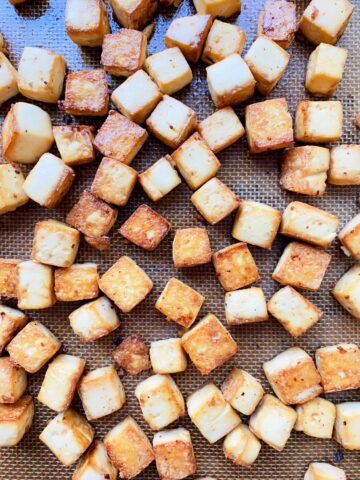 A close up image of Essential Baked Tofu Cubes on a baking tray.