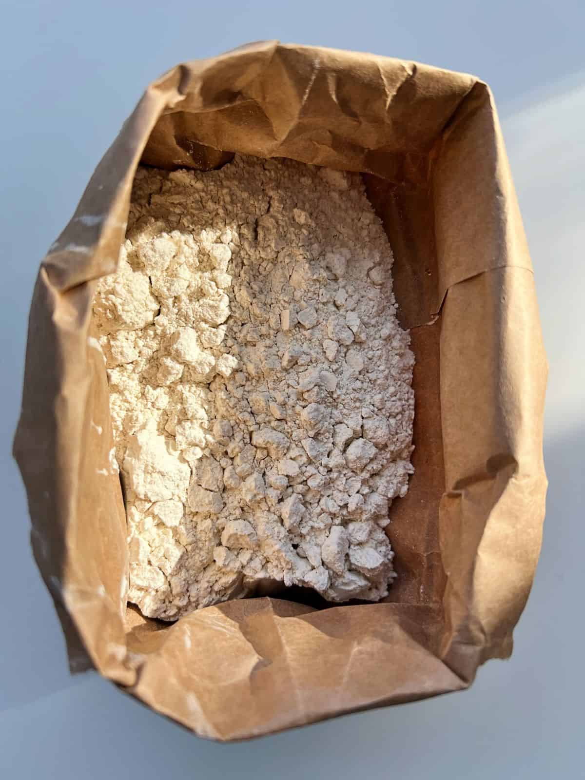 An image of whole wheat pastry flour in a brown paper bag.