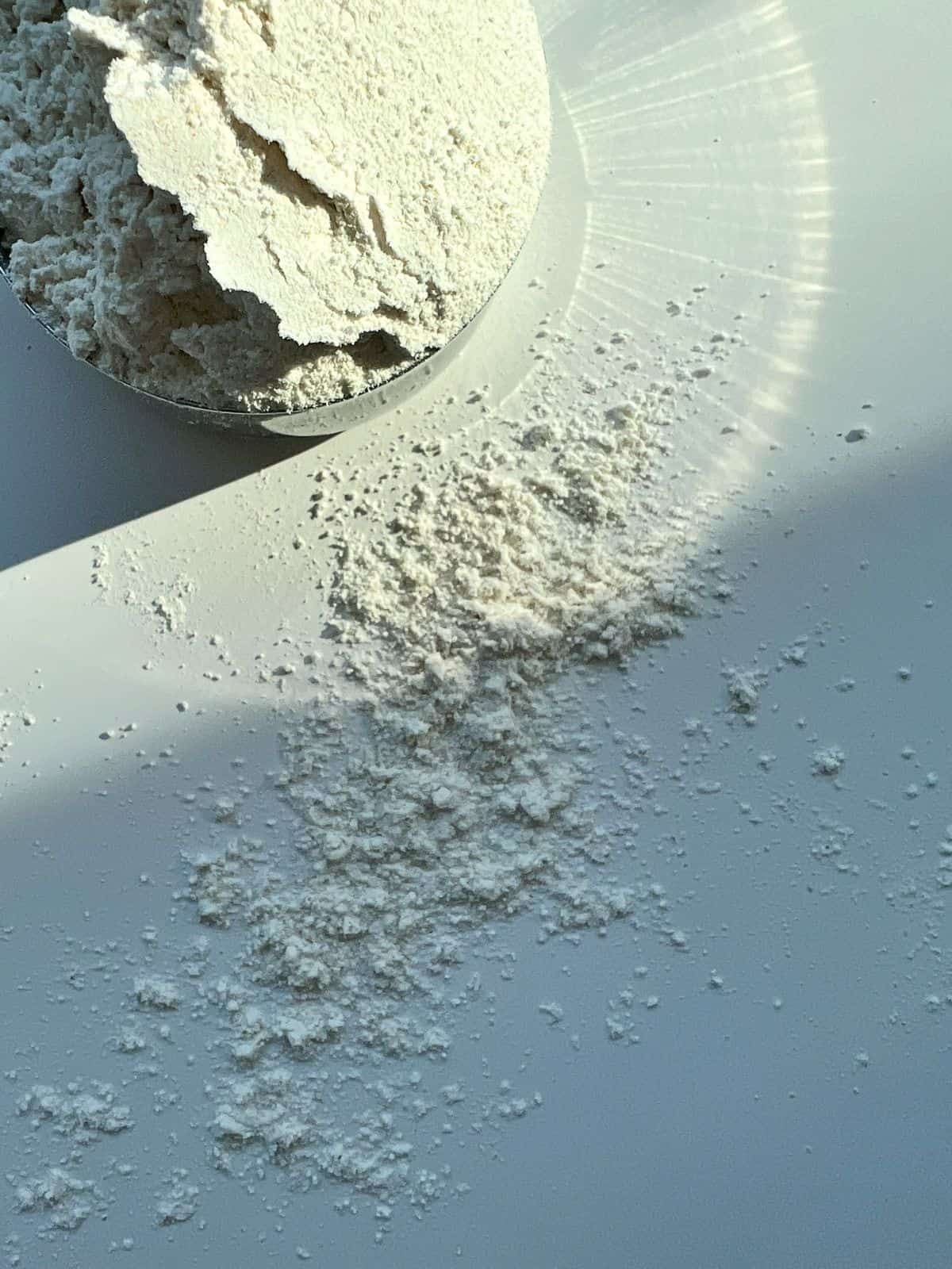 A close up image of a cup of whole wheat pastry flour showing the texture of the flour.