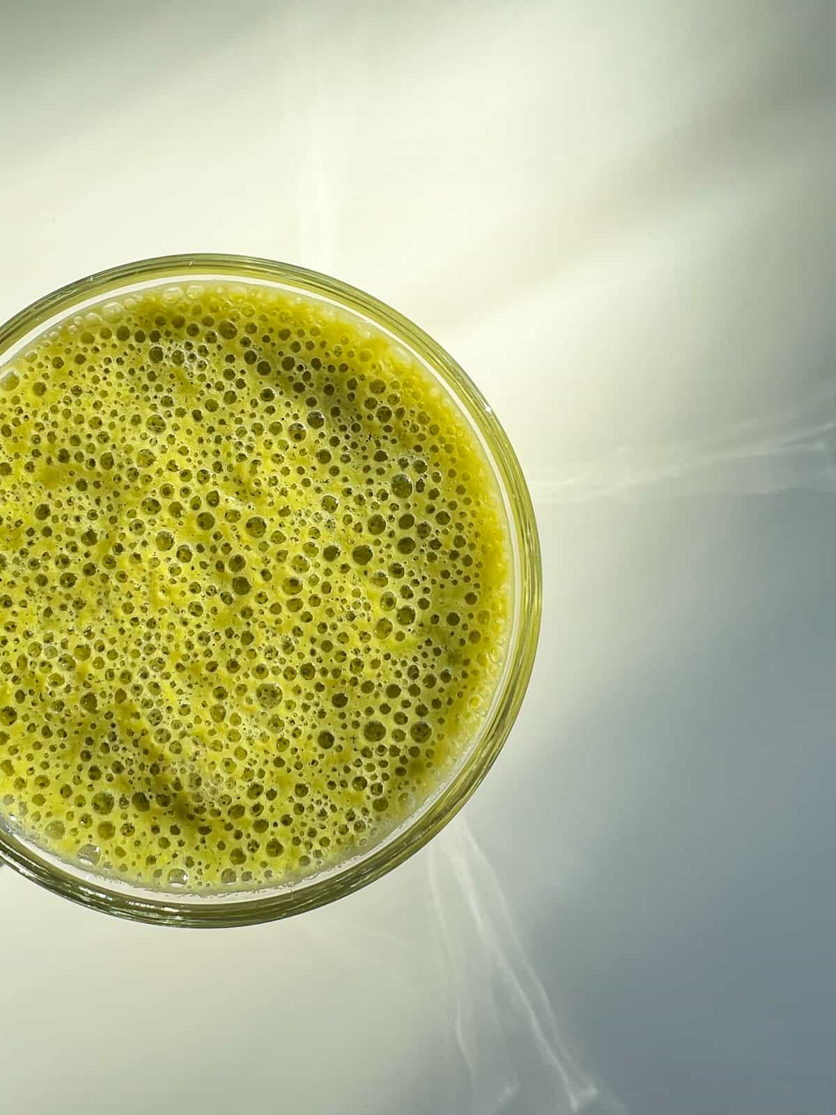 An image of a green smoothie as seen from above.