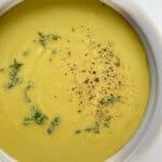 An image of Smoky Herbed Split Pea Soup in a white and grey ceramic bowl.