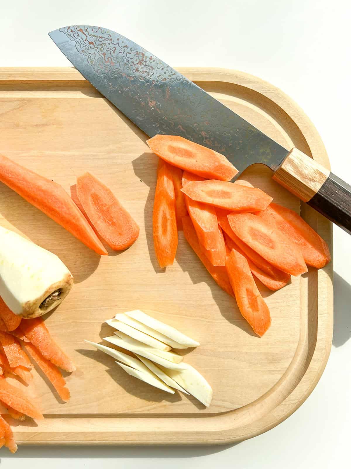 The vegetables added to the soup being cut into small slices.