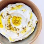 An image of Simple Herbed Labneh in a ceramic bowl.