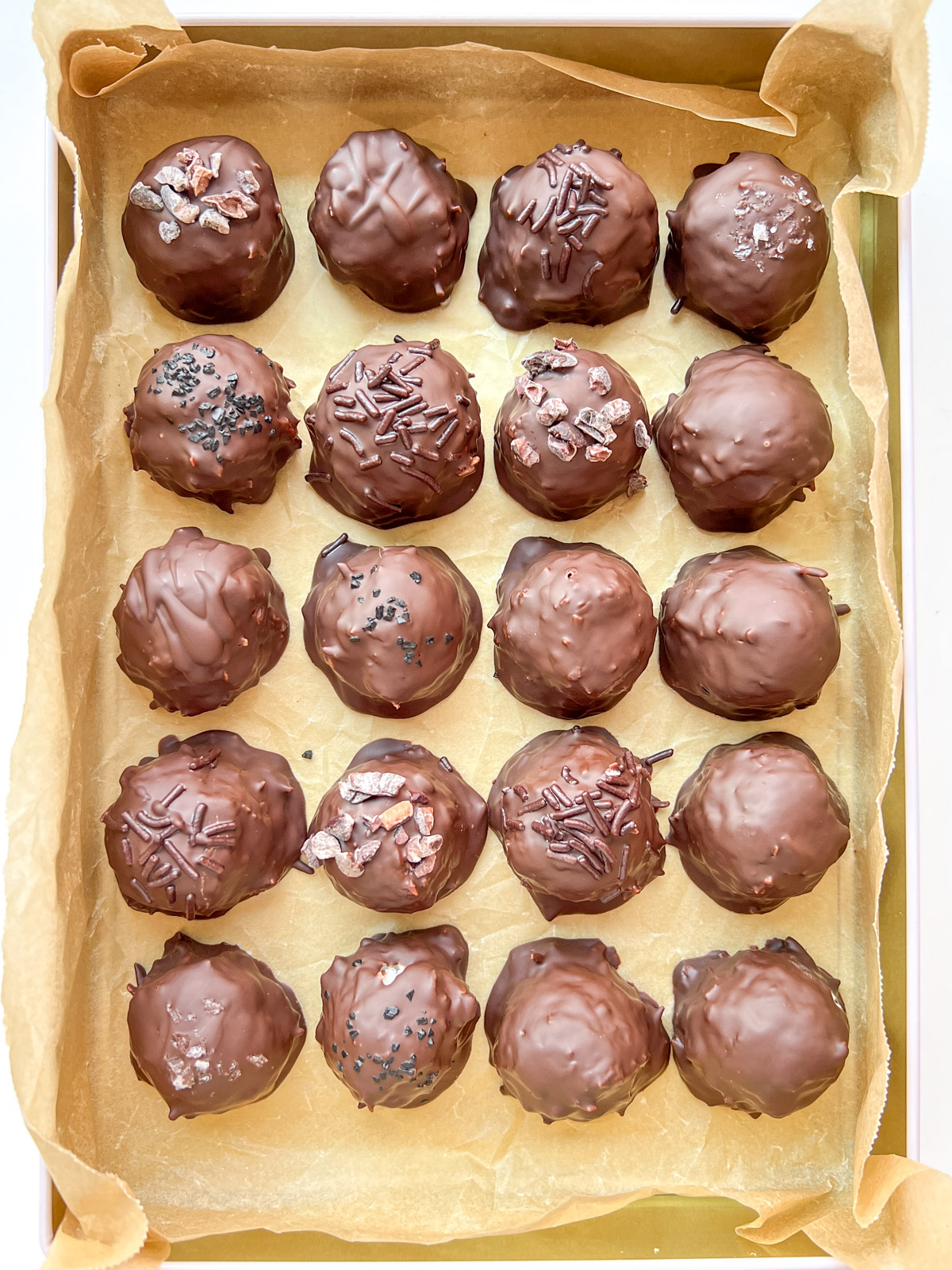 An image of a tin filled with Chocolate Coconut Bonbons.