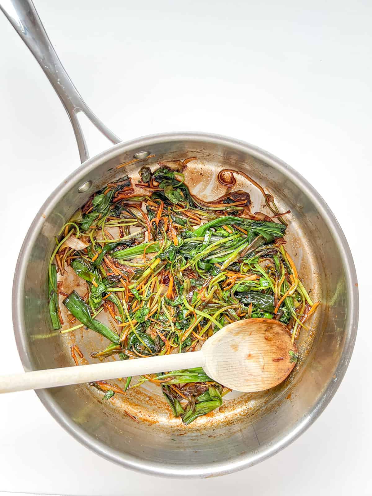 An image of the vegetables used in this recipe cooked inside a saute pan.