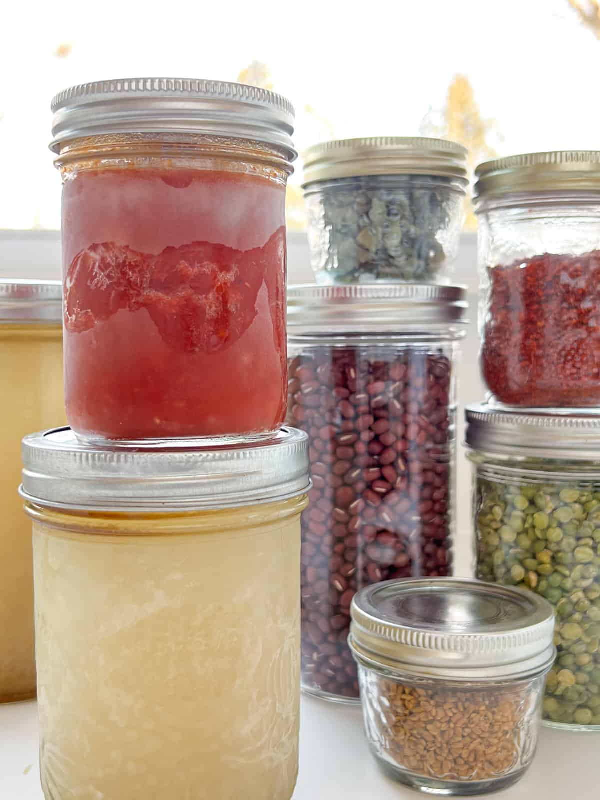 An image of a selection of glass mason jars in various sizes.