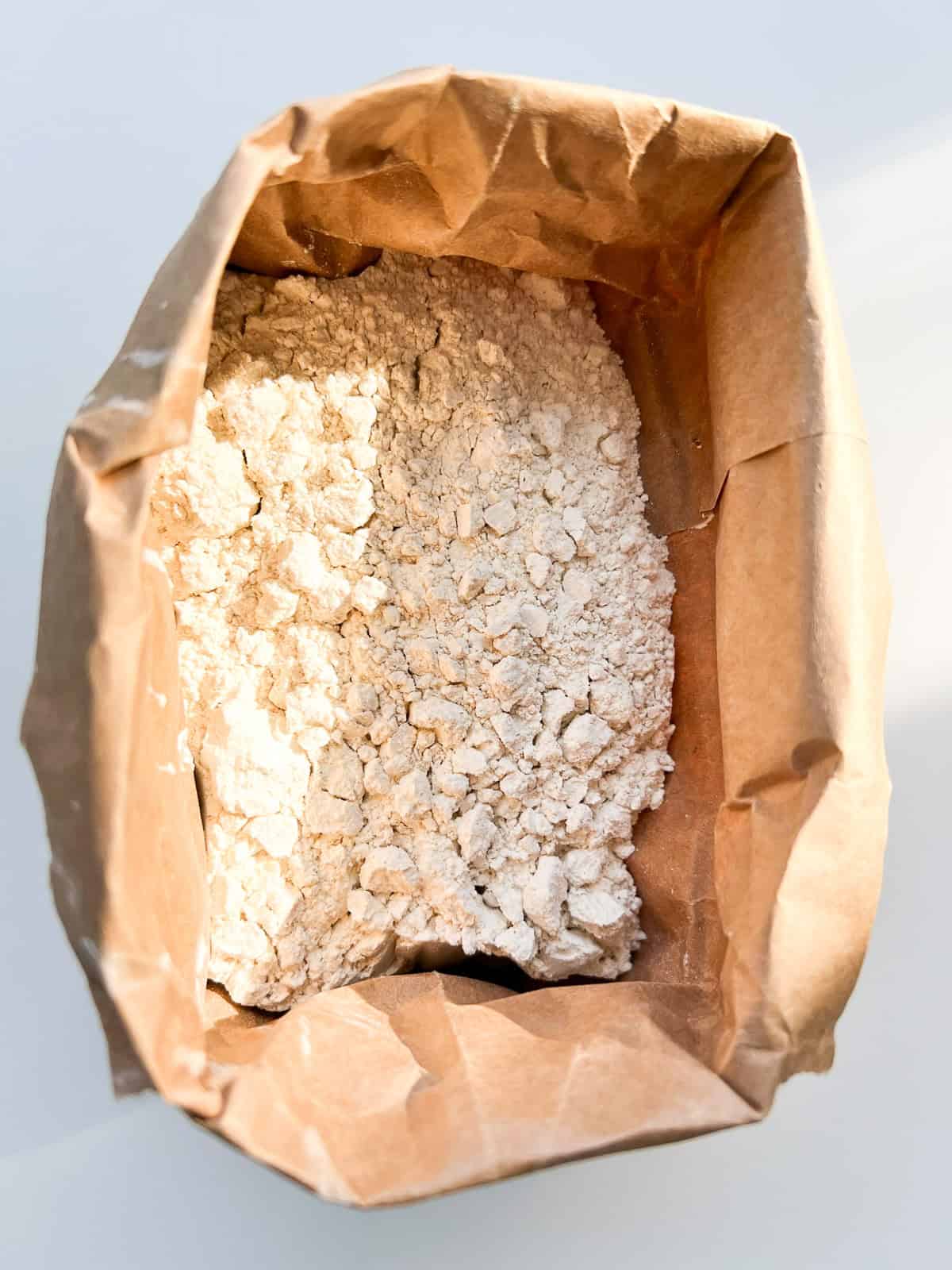 An image of whole wheat pastry flour in a brown paper bag.