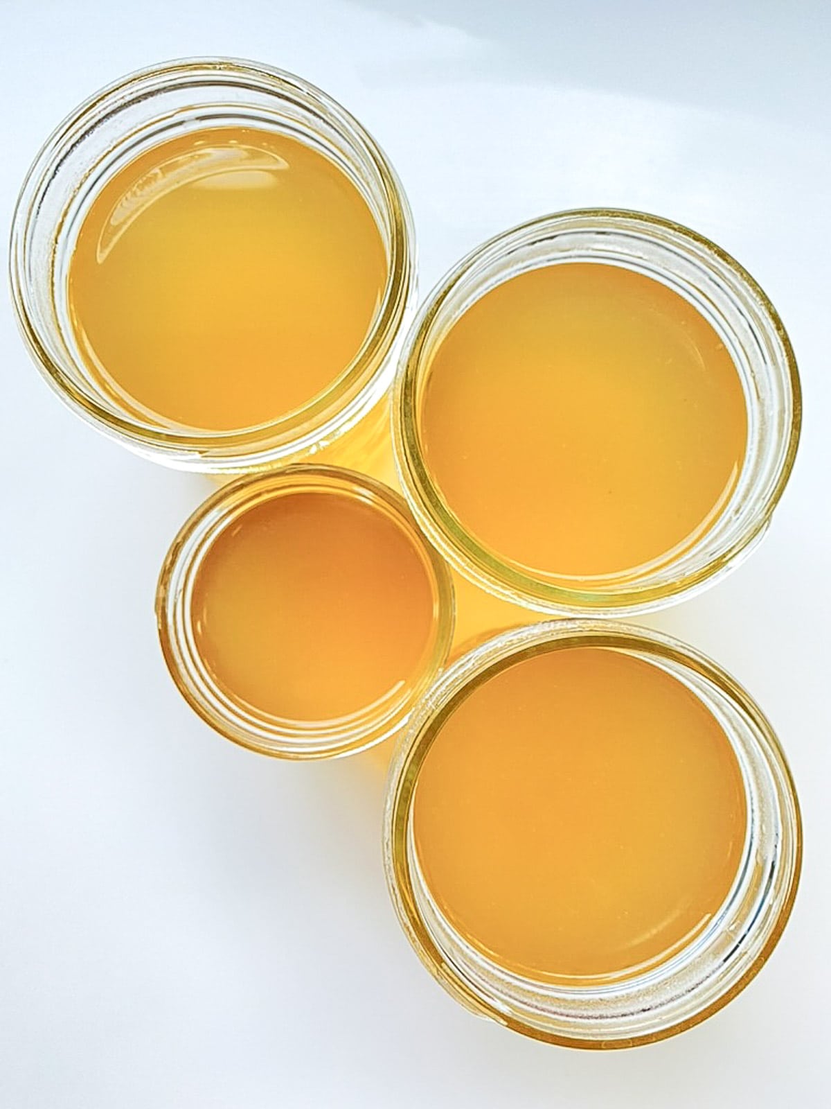An image of mason jars filled with corn broth.