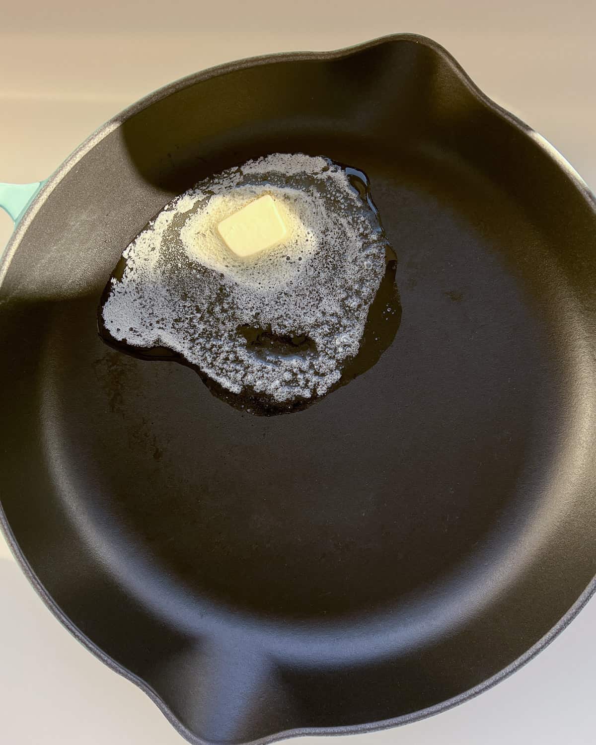 An image of butter being melted in a pan ready to pan crips some bread cubes into croutons.