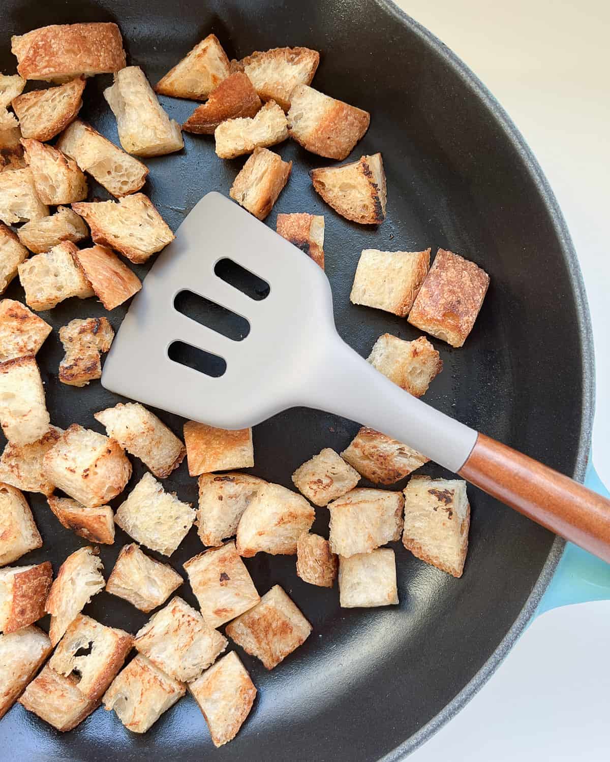 Pan crisped croutons in a pan.