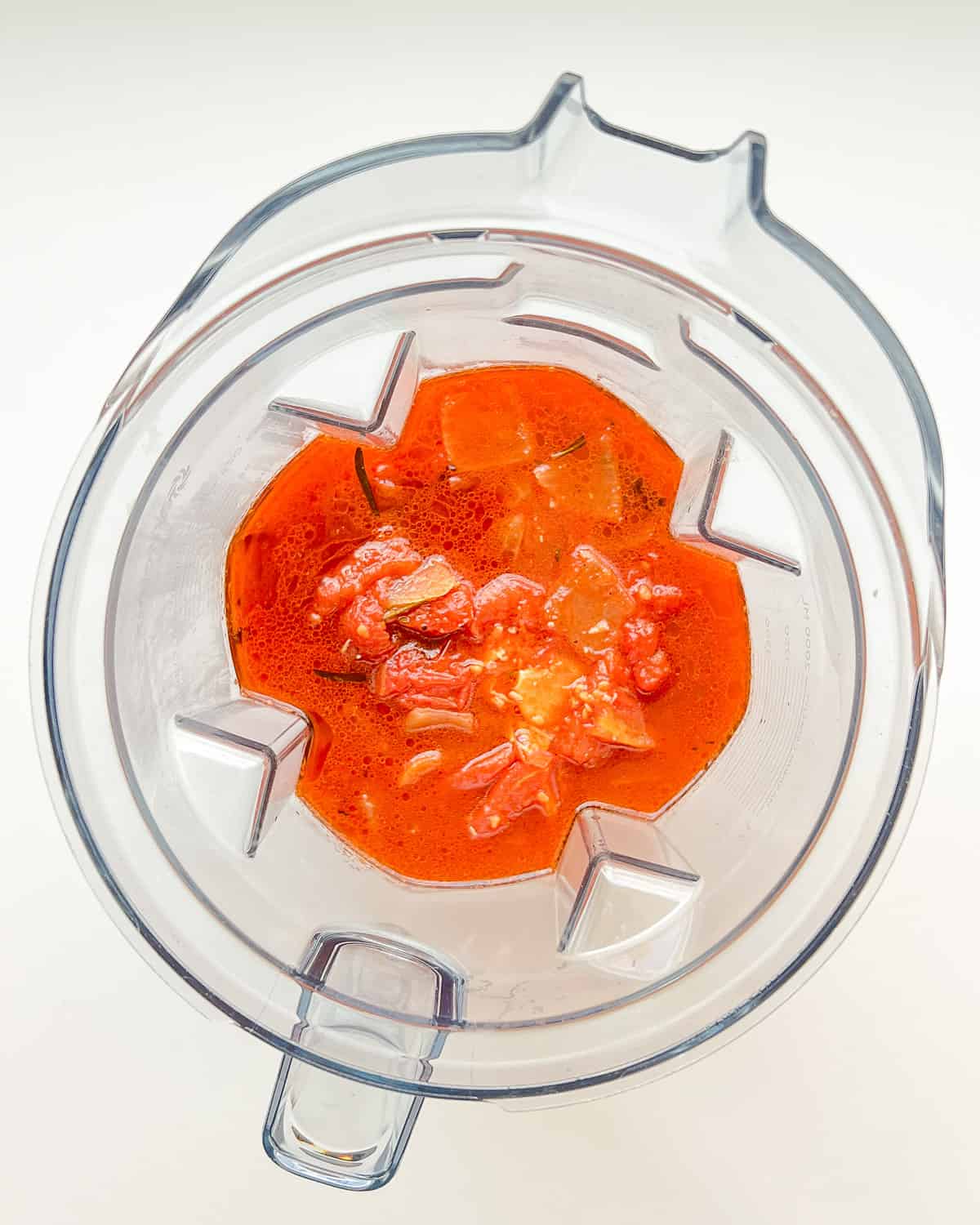 An image of cooked Roasted Tomato Soup and Garlic in a blender canister before being blended.