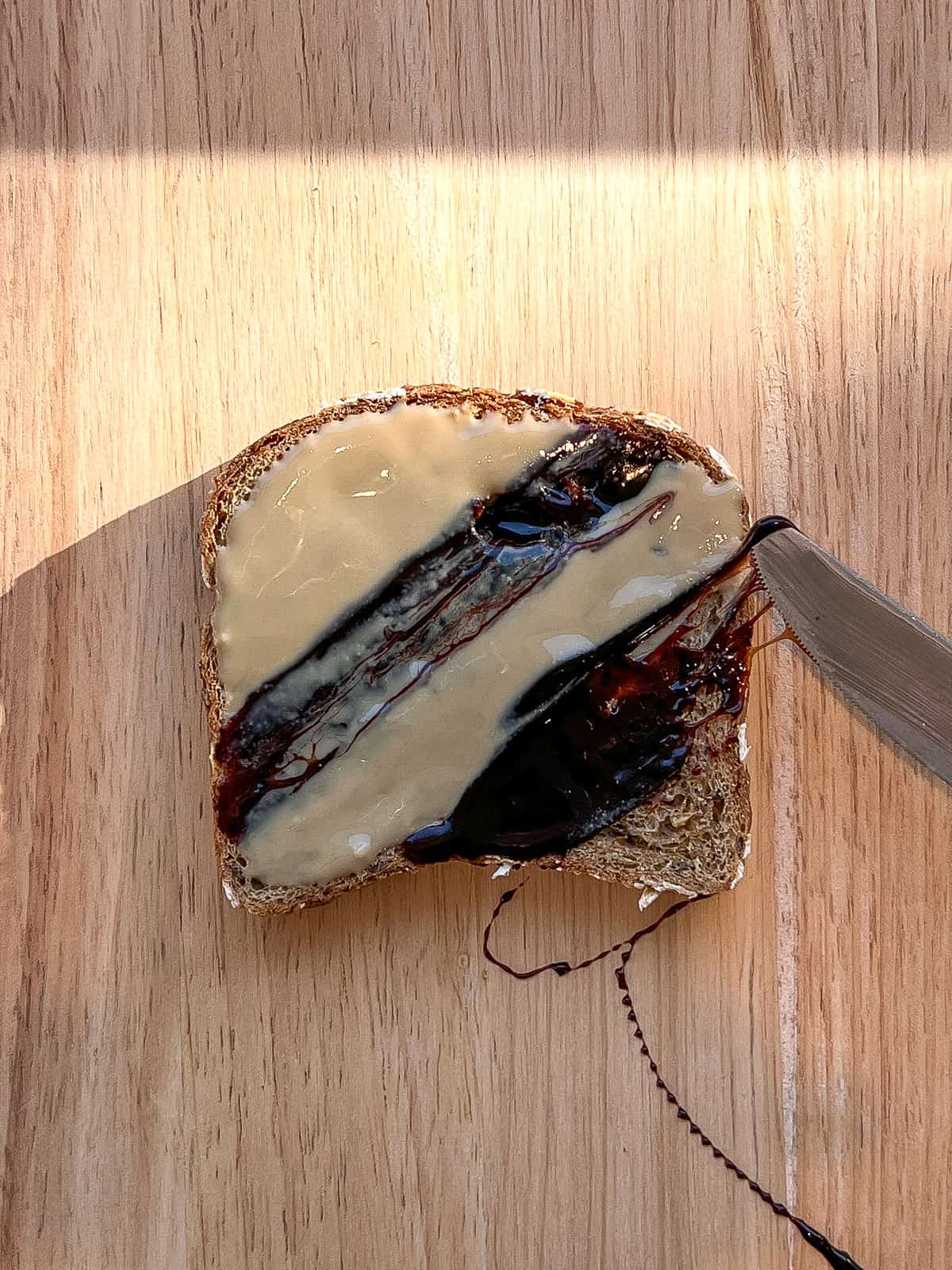 An image of date syryp being drizzled on toast.