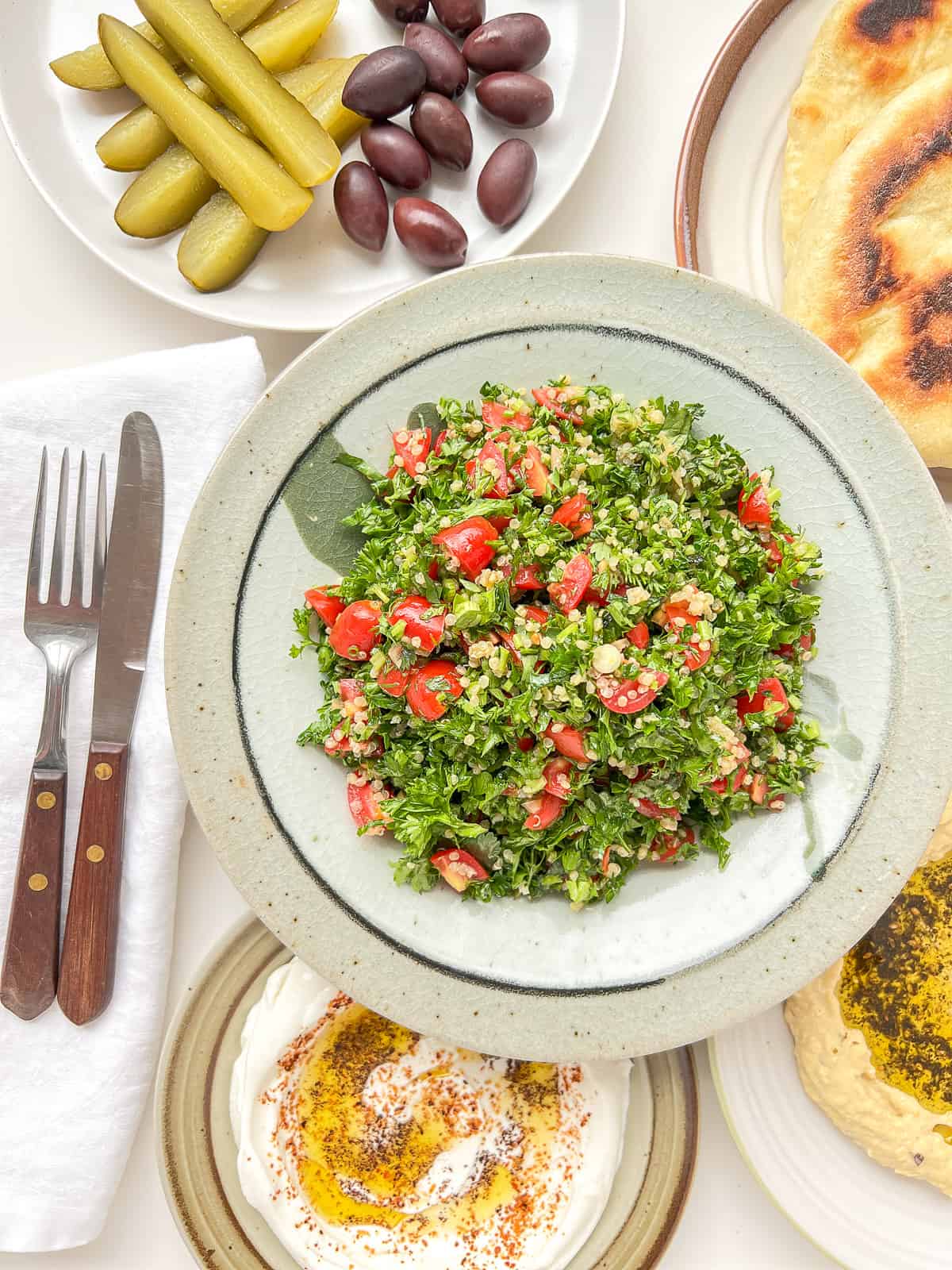 An image of a plate of tabbouleh surrounded by other meze dishes.