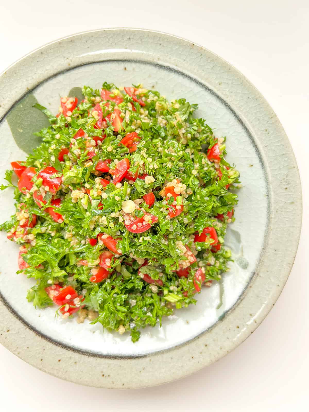 A ceramic dish filled with tabbouleh.