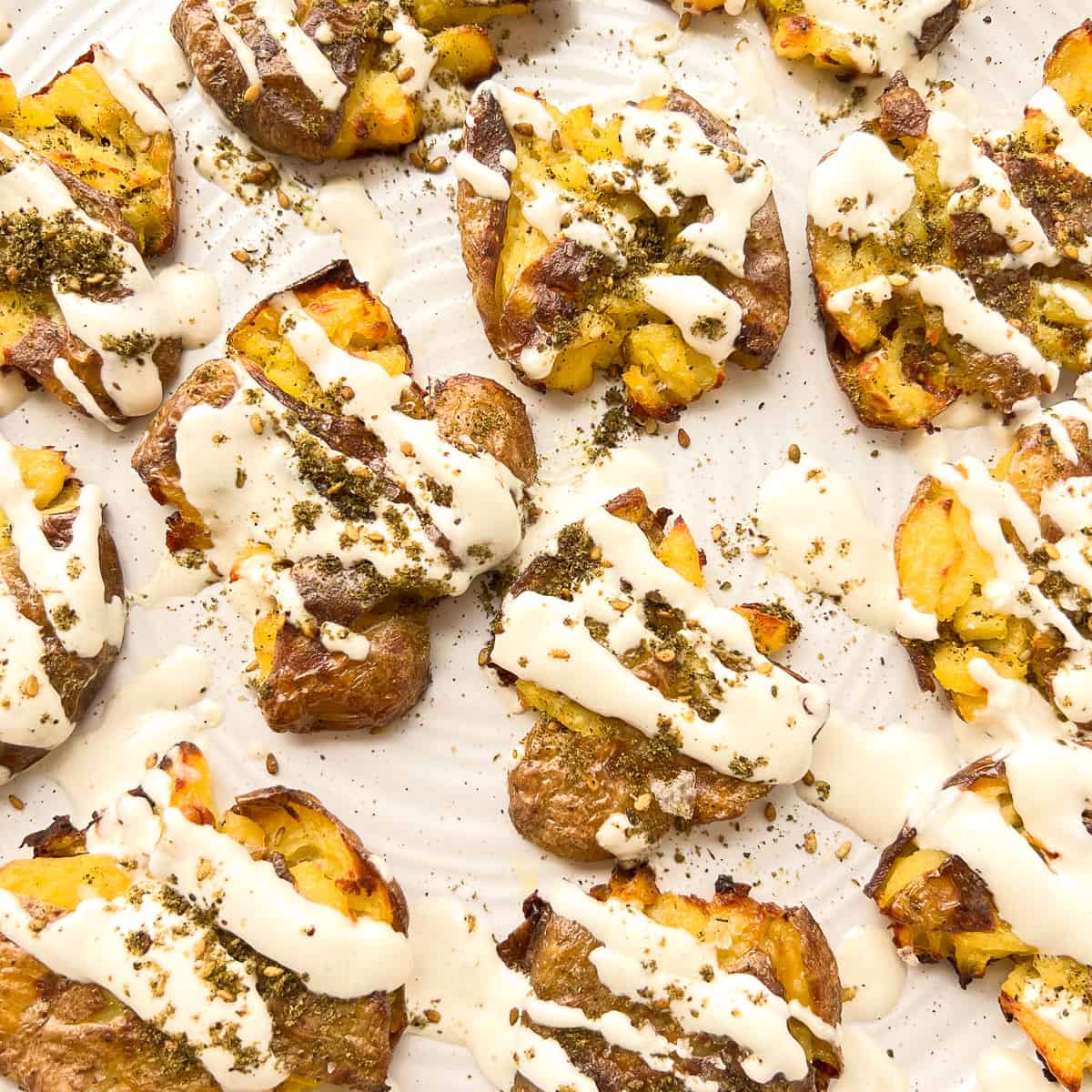 Crispy Smashed Garlic Potatoes with Tahini and Za'atar