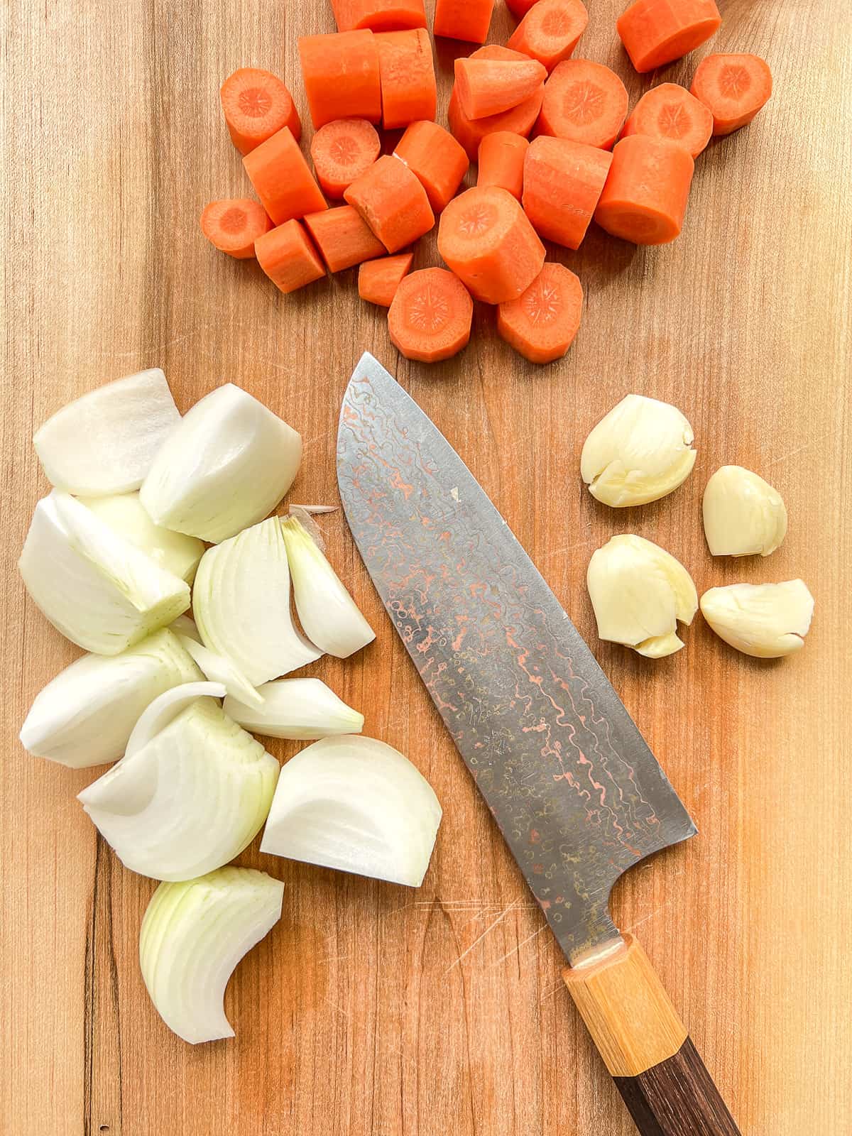 An image of chopped vegetables on a chopping board.