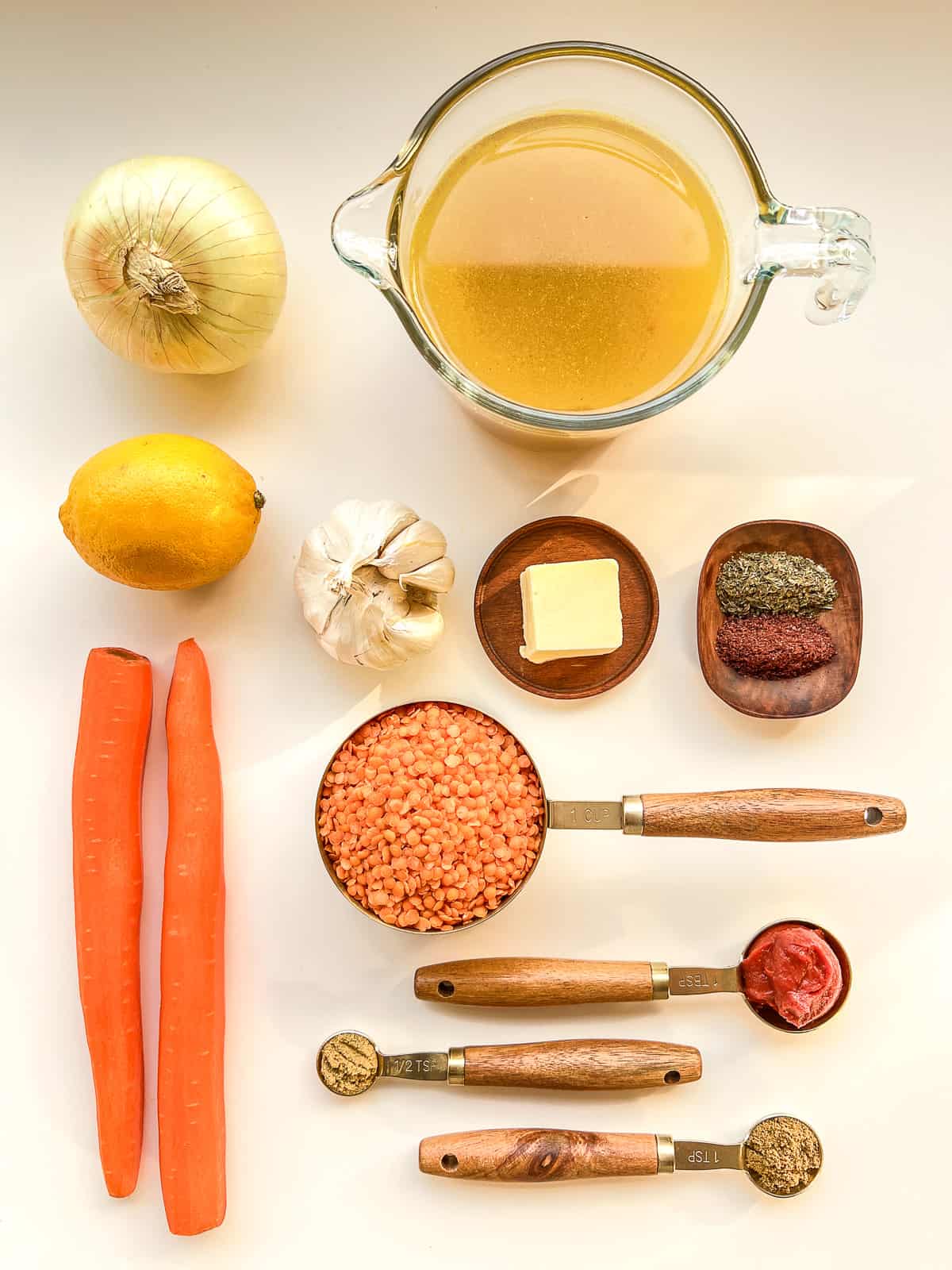 An image of the ingredients needed to make lentil soup against a white background.