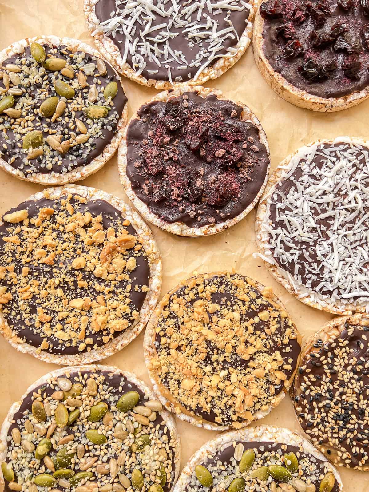 An image of a variety of homemade Chocolate Rice Cake Treats on a parchment paper lined tray.