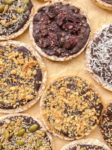 A close up image of a variety of homemade Chocolate Rice Cake Treats on a parchment paper lined tray.
