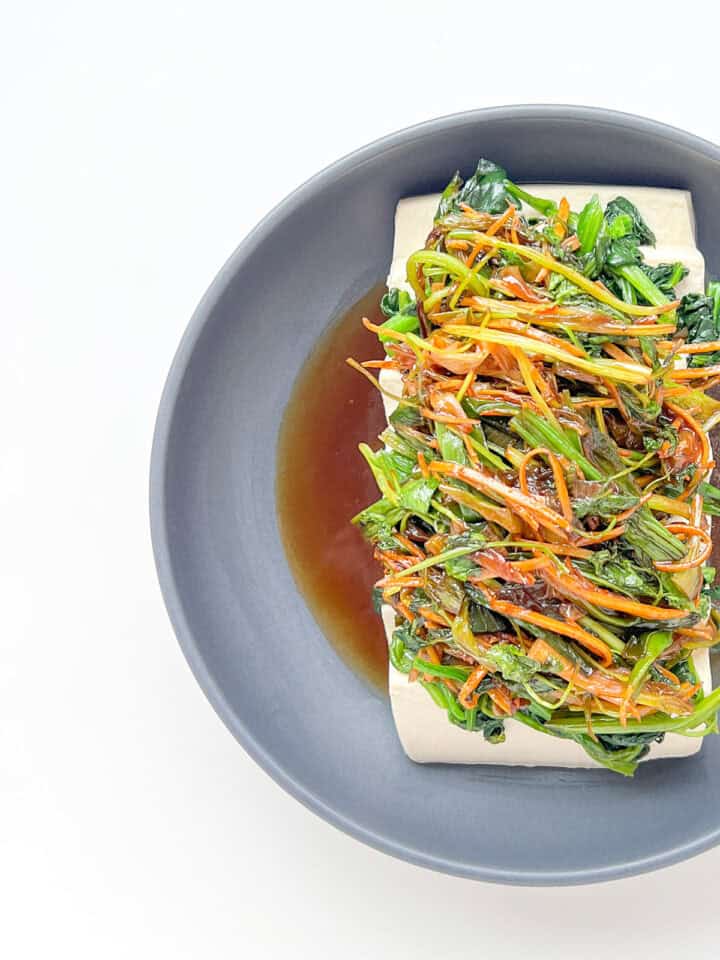 An image of Steamed Silken Tofu with Ginger and Fragrant Greens.