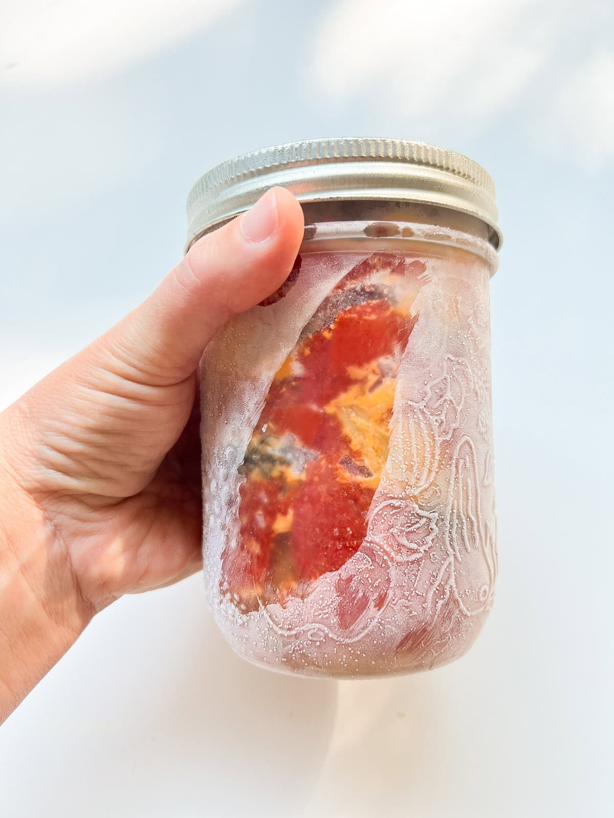 An image of a frozen jar of Oven Roasted Tomatoes.